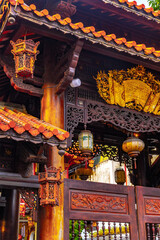 Intricate chinese temple details with lanterns and carved wood decorations