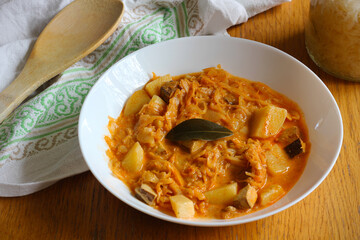 Healthy version of traditional Czech and Slovak cabbage soup (called zelnacka or kapustnica) cooked from sauerkraut, potatoes, cumin, sweet pepper, cream and smoked tofu cheese instead of sausage