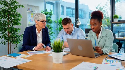 Multiracial business professionals collaborate on project strategy, analyzing data in a modern office. - Powered by Adobe