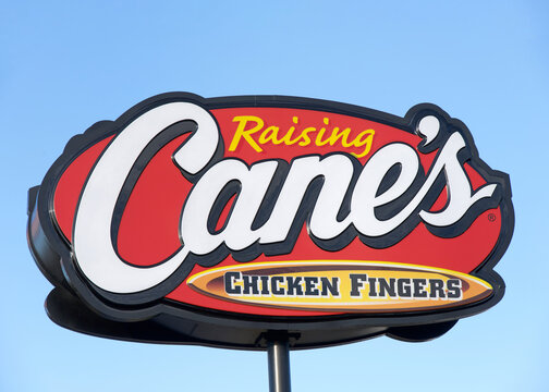San Diego, CA - Dec 29, 2025: Close up on Raising Cane's Fast food Restaurant sign. An American fast-food restaurant chain specializing in chicken fingers founded in Baton Rouge, Louisiana.