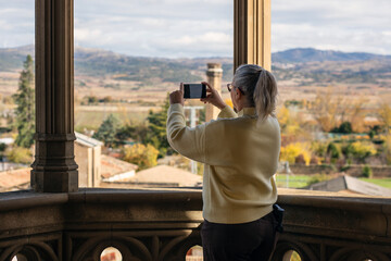 Capturing the serene landscape from a historic balcony in autumn hues near a charming village