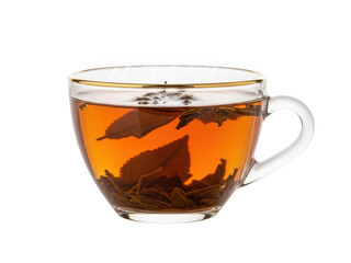 A transparent glass teacup filled with amber tea and loose tea leaves