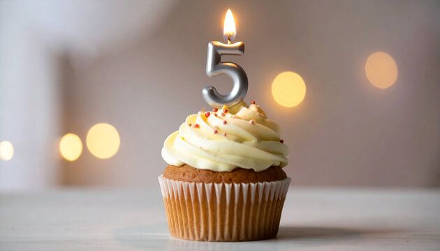 Birthday cupcake topped with creamy frosting, number 5 candle burning, sweet food, festive dessert.