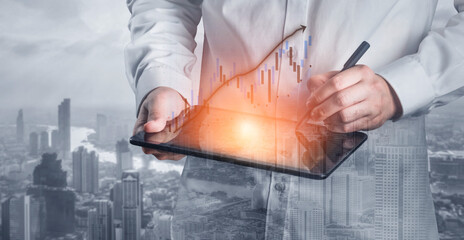 A business professional using a digital tablet to analyze financial data with an urban skyline in the background, highlighting modern technology integration in business. Impute