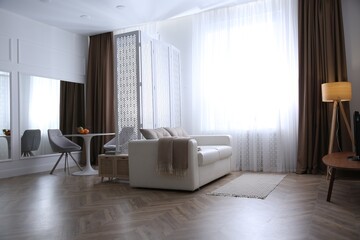 Modern living room with parquet floor and stylish furniture