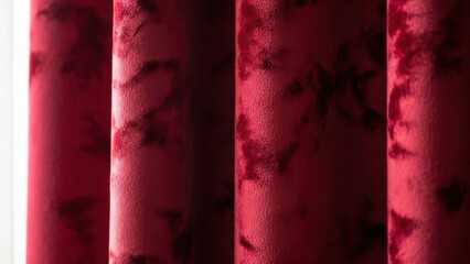 Elegant Red Fabric Drapes with Abstract Floral Pattern.
