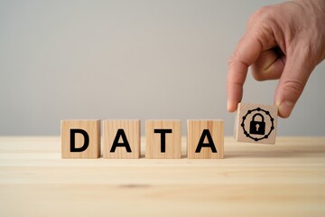 Data protection and digital security concept. Wooden blocks with text DATA and padlock icon. Data protection, privacy, cybersecurity, secure networks, encryption and safeguarding information. 