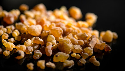 Frankincense olibanum resin, Boswellia sacra Isolated on black background. Frankincense or olibanum aromatic resin using in incense and perfumes, medicine, religion concept. Incense, Fragrance.  