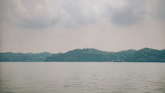 Coastal View of Guimaras Island with Lush Green Hills and Overlooking Signage from the Sea, Tropical Seascape and Mountain Horizon, Philippines