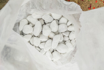 Sack full of rounded white pebbles
