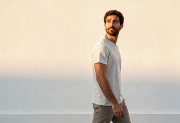 Charismatic spanish man enjoying a walk in the sunset light - capturing leisure and confidence