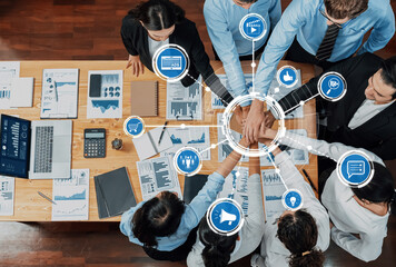 A top-down view of a business team engaged in a collaborative meeting, focusing on data analysis and digital technology tools for strategic decision-making. Amity