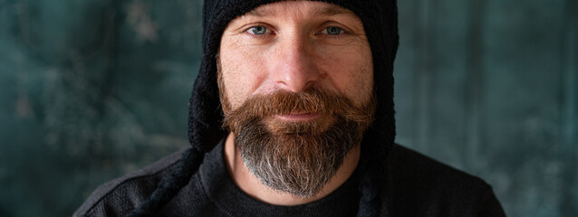 Bearded man wearing black knit hat, authentic portrait with natural light