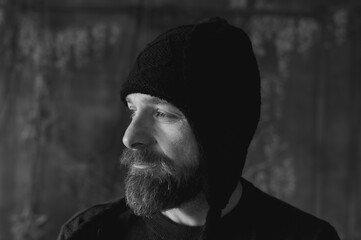 Bearded man wearing black knit hat, authentic portrait with natural light