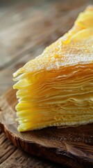 Crepe cake slice with flower decorations: A exquisite durian fruit mille crepe cake with flowers, presented elegantly on a plate