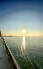 A stunning sunset casts enchanting reflections on calm waters, ideal for serene and peaceful moments