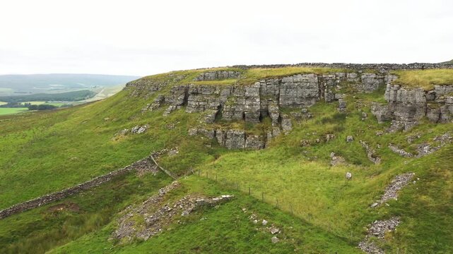Limestone scarp of High Hurth Edge, Upper Teesdale. Site of Moking Hurth Cave. Important Ice Age environment and cave paleo finds. Human, lynx etc. Video panorama sweep E &ndash; W across cave entrances 