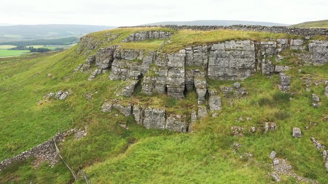 Limestone scarp of High Hurth Edge, Upper Teesdale. Site of Moking Hurth Cave. Important Ice Age environment and cave paleo finds. Human, lynx etc. Video travel east to west across cave entrances