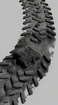 Dirt flying off moving bicycle tire leaving tread marks in slow motion for dynamic sport advertisement