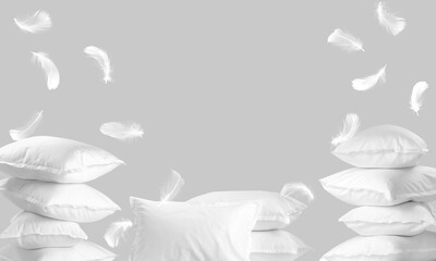 Pillows and flying feathers on pastel grey background. Sleep comfort. Poster with space for text