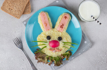 Funny bunny from mashed potato and sausages, natural yogurt in glass and bread for breakfast kids meal