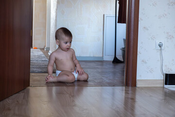 Baby Crawling Near Robotic Vacuum on Wooden Floor Copy Space