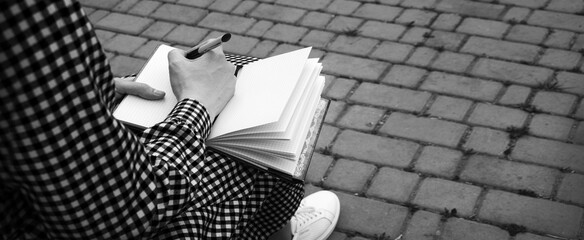 Girl holds a book to write