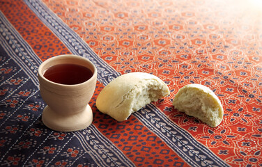 Wine in a gobled and bread