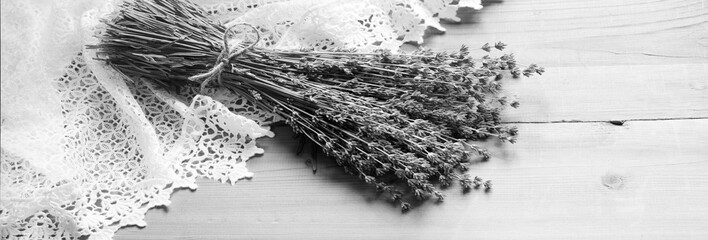 Lavender flowers lie on the table on lace