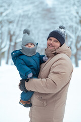Portrait Father and Baby Enjoying Winter in Snowy Park