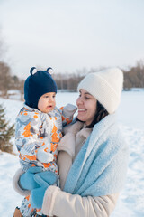 Smiling Mother and Baby Enjoying a Winter Day
