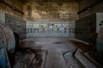 Vintage machinery inside an abandoned sugar refinery in Italy. Rusted equipment and industrial...