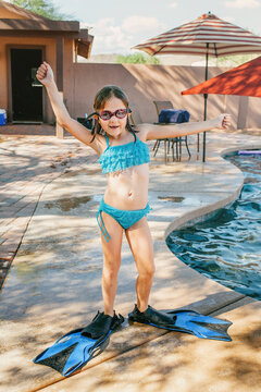 Young girl by pool with scuba gear