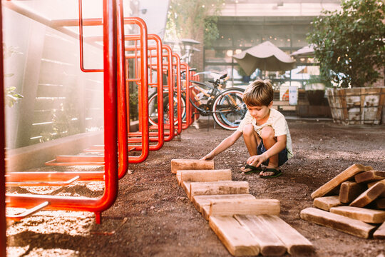boy on the playground building blocks