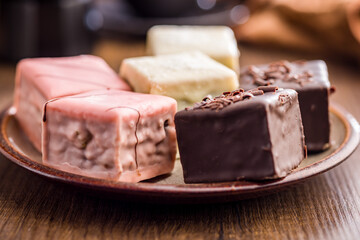 Sweet dessert cake. Mini pie on plate on wooden table.