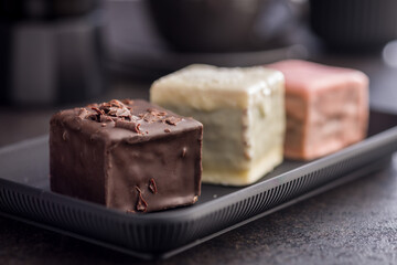 Sweet dessert cake. Mini pie on plate on black table.