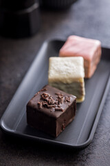 Sweet dessert cake. Mini pie on plate on black table.