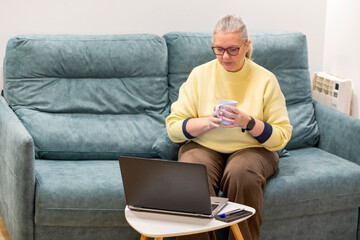 Relaxing at home with a warm drink while working on a laptop during a cozy afternoon