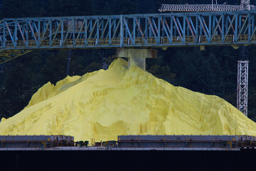 A bulk load of sulphur at a dockside ready to be loaded on a ship