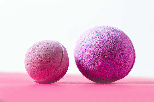 Colorful bath bombs in different sizes placed on a flat surface against a light background - Powered by Adobe