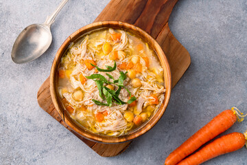 Delicious chicken soup with chickpeas served on an old stone table.	
