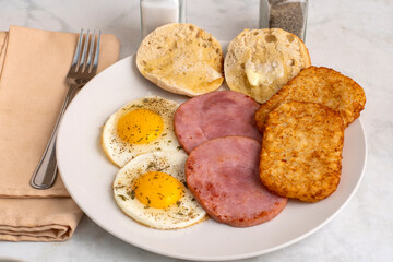 fried eggs  with hash browns and ham