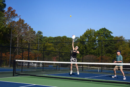 Ball Flies Past Jumping Pickle Ball Player