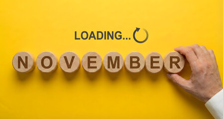 hand building november on wooden blocks with loading text