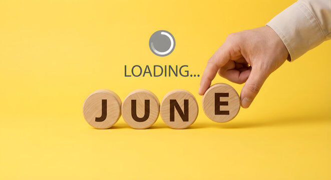 June loading concept with wooden blocks and hand