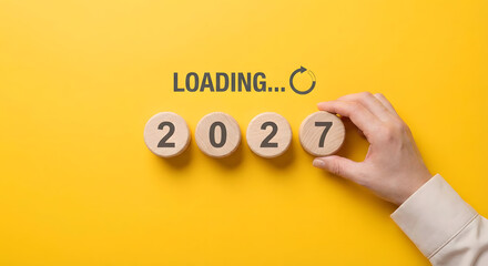 New year 2027 concept with wooden blocks and hand
