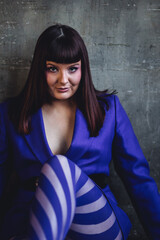 Body positive concept. Sexy elegant beautiful gorgeous self confident plus size middle age woman in a violet suit and tights