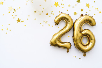 Golden 26 balloon with star confetti on white background