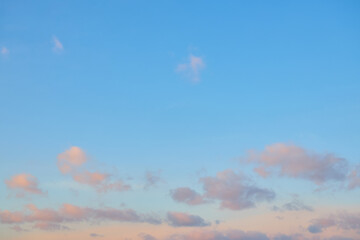 Beautiful blue sky with pink clouds at sunset.