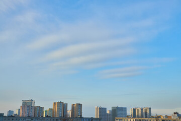 City skyline with residential buildings under a blue sky.